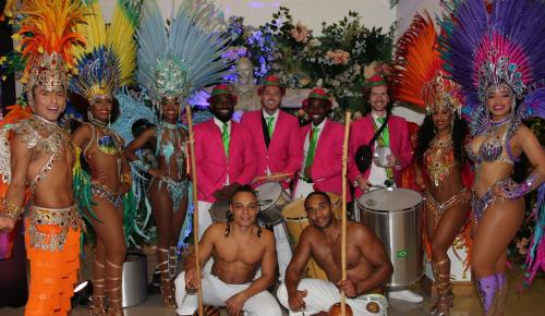 colourful dancers and drummers at the charity ball