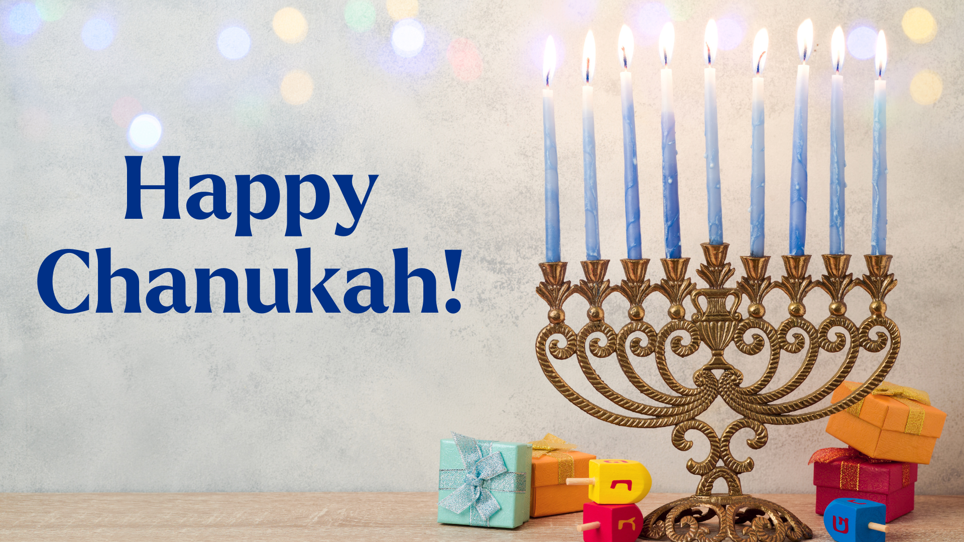 A graphic featuring a lit menorah, dreidels and Chanukah gelt. On the left, the text reads 